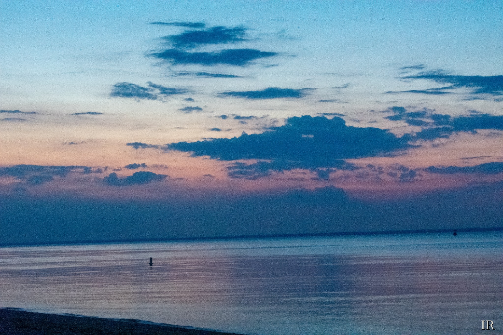 Blue-hour sky and calm water in soft pink and blue tones